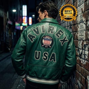 May include: A green leather jacket with white trim and the text "AVIREX USA" on the back. The jacket features a patch with an American flag design. The jacket is a bomber style.