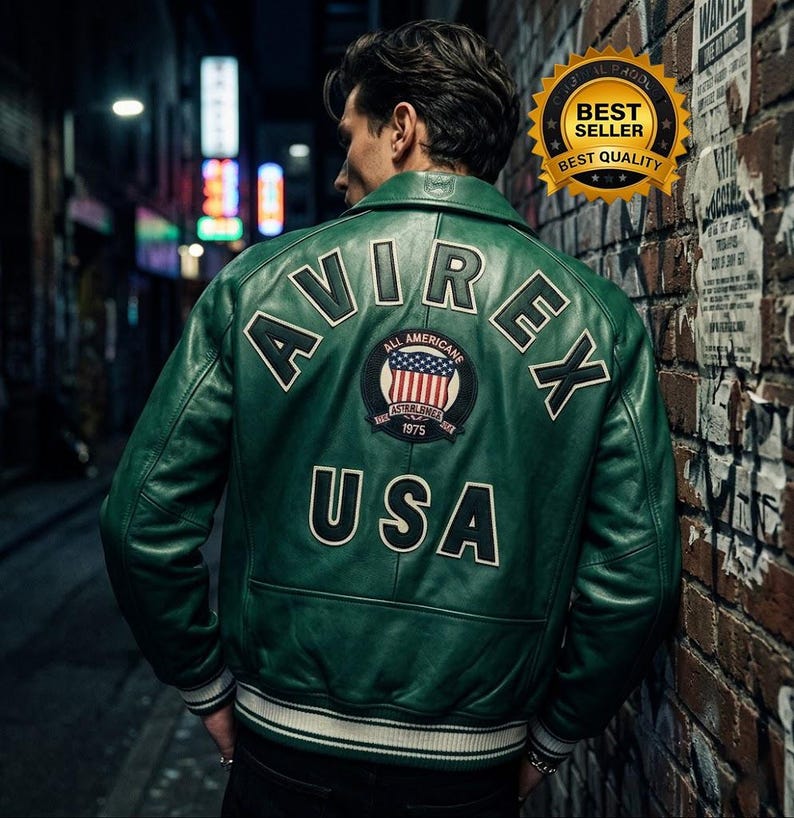 May include: A green leather jacket with white trim and the text "AVIREX USA" on the back. The jacket features a patch with an American flag design. The jacket is a bomber style.