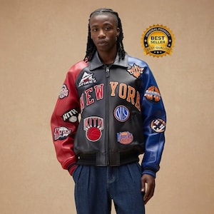 May include: A black, red, and blue leather jacket with the words "NEW YORK" in orange and white. The jacket has multiple patches, including basketball-themed designs and the word "KITH". The jacket has a zipper closure and a black collar.