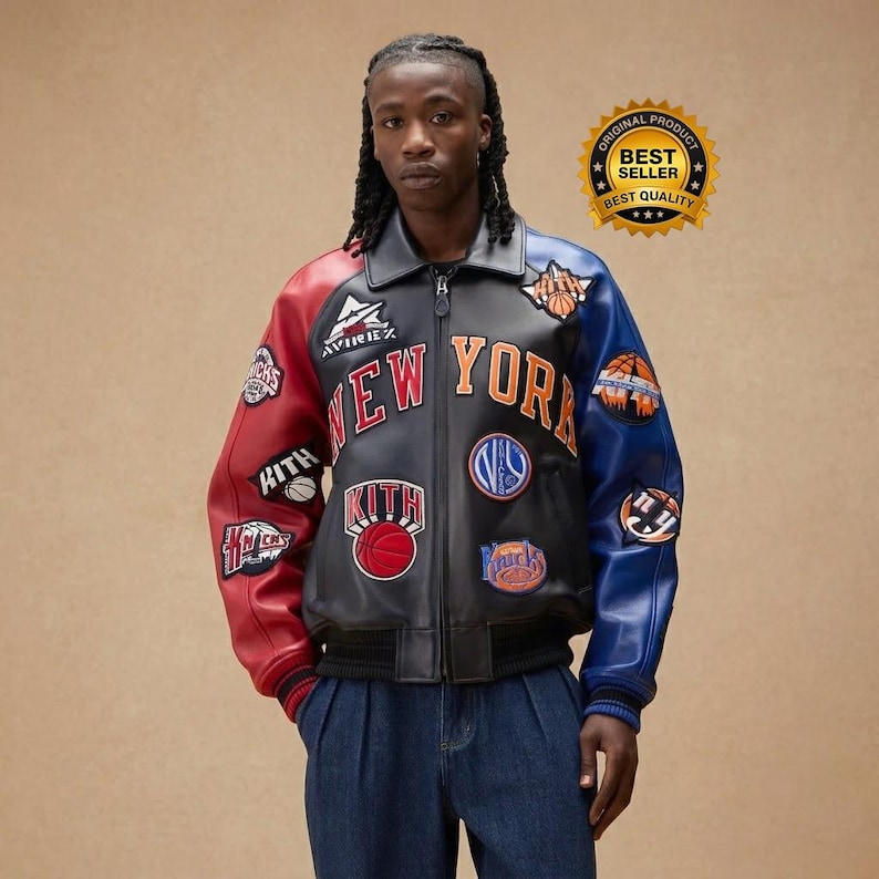 May include: A black, red, and blue leather jacket with the words "NEW YORK" in orange and white. The jacket has multiple patches, including basketball-themed designs and the word "KITH". The jacket has a zipper closure and a black collar.