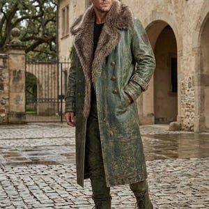 May include: A long, distressed green leather coat featuring a large, thick brown faux fur collar, double-breasted button closure, and matching green leather trousers. The coat includes buckled sleeve straps and a small patch on the left shoulder.
