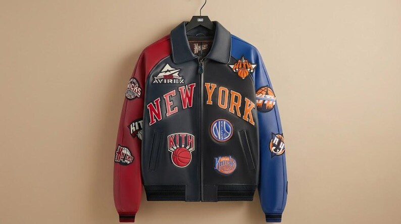 May include: A black, red, and blue leather jacket with "NEW YORK" and basketball-themed patches. The jacket features a zip-up front, a collar, and the "AVIREX" logo. The sleeves are red and blue.