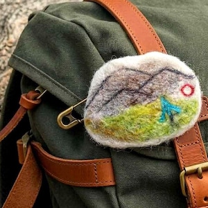 May include: A white ceramic mug with a black handle and the text "But First, Coffee" in a bold, black font. The mug is sitting on a wooden surface. The mug is approximately 4 inches tall.