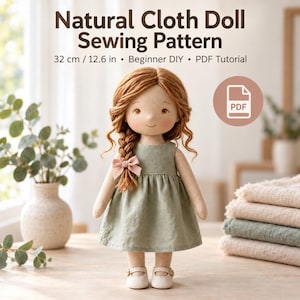 May include: A cloth doll with auburn yarn hair in a side braid, wearing a sage green dress and a small pink bow. The text reads Natural Cloth Doll Sewing Pattern, 32 cm / 12.6 in, Beginner DIY, PDF Tutorial, with a PDF icon.
