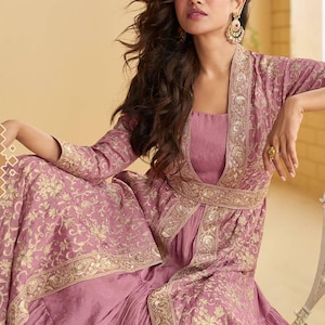 May include: A mauve embroidered outfit, comprising a long-sleeved jacket and dress. The jacket and dress feature gold floral embroidery. This traditional style outfit is suitable for special occasions and celebrations.