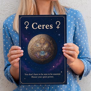 May include: A dark blue poster with the text "? Ceres ?" and "TAROTICON". The poster features a detailed illustration of a planet with celestial elements. The bottom of the poster reads, "You don't have to be seen to be essential. Honor your quiet power."