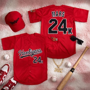 May include: A red baseball jersey with "Mars 24K" on the back and a matching cap with "Hooligans" embroidered on it. The image also includes a baseball bat, sunglasses, a gold chain, and baseballs.