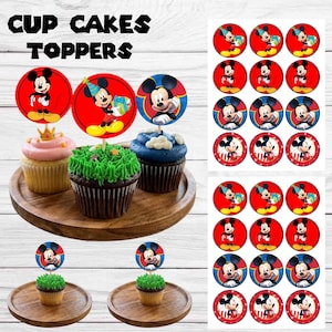 May include: A set of circular cupcake toppers featuring Mickey Mouse in various poses, including holding a gift and wearing a party hat. The toppers are displayed on cupcakes and as a printed sheet with the text CUP CAKES TOPPERS at the top.