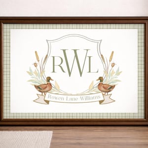 May include: Framed artwork featuring a watercolor design with two ducks, cattails, and a banner that reads "Rowen Lane Williams." The artwork has a light green plaid background and a dark brown frame. The initials "RWL" are in the center.