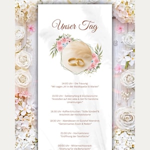 May include: A wedding invitation card titled Unser Tag featuring two gold rings inside a geometric frame surrounded by pink and green floral illustrations. The border displays white flowers on a wood-textured background with a detailed event schedule.