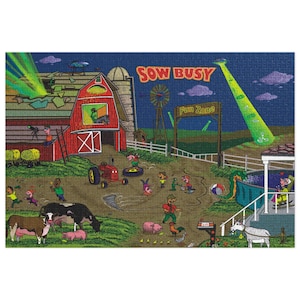 May include: A colorful jigsaw puzzle featuring a farm scene with a red barn, tractor, and various farm animals. The puzzle includes the text "Sow Busy" and "Fun Zone", with cartoon characters and a UFO beam.