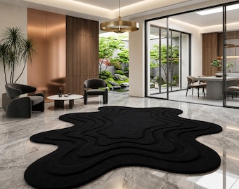 Alfombra de lana orgánica negra, alfombra con mechones abstractos irregulares, sala de estar minimalista moderna.