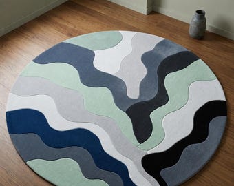 Alfombra redonda abstracta moderna, con estampado de olas azules y verdes, ideal para decorar el suelo de la sala de estar con un estilo minimalista.