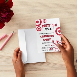 May include: A white rectangular party invitation card with red bullseye graphics and red text that reads Party on Aisle 1, Celebrating Emmett, Saturday May 2, 2026, 1pm-3pm, Address: 123 House St, RSVP to: 123-456-7890, accompanied by a plain white envelope.