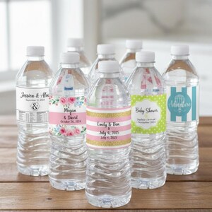 May include: A collection of clear plastic water bottles with custom labels featuring various designs, including floral patterns, pink and gold stripes, green polka dots, and blue stripes with text like Jessica & Alex, Megan & David, and Emily & Ben.