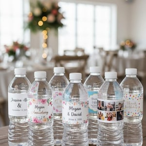 May include: Clear plastic water bottles with white caps and personalized labels. Labels include names, dates, and floral designs, suitable for a wedding or anniversary. The bottles are arranged on a wooden surface, with a blurred background.