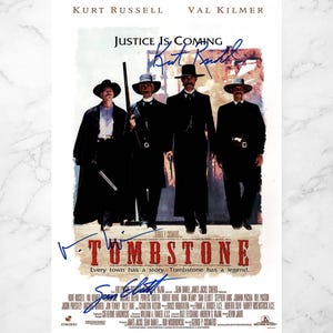 May include: A film poster for "Tombstone" starring Kurt Russell and Val Kilmer. The image shows four men in black attire and hats. The title "Tombstone" is prominently displayed, along with the tagline "Every town has a story. Tombstone has a legend."