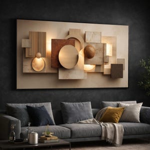 Op de afbeelding: Abstracte wandkunst met een geometrisch ontwerp. Het bevat houten en metalen elementen, waaronder vierkanten, cirkels en bollen in verschillende bruin- en beigetinten, met warme lichtaccenten. Het kunstwerk is zwart omlijst.