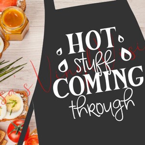 May include: Black apron with white text that reads "HOT stuff COMING through".