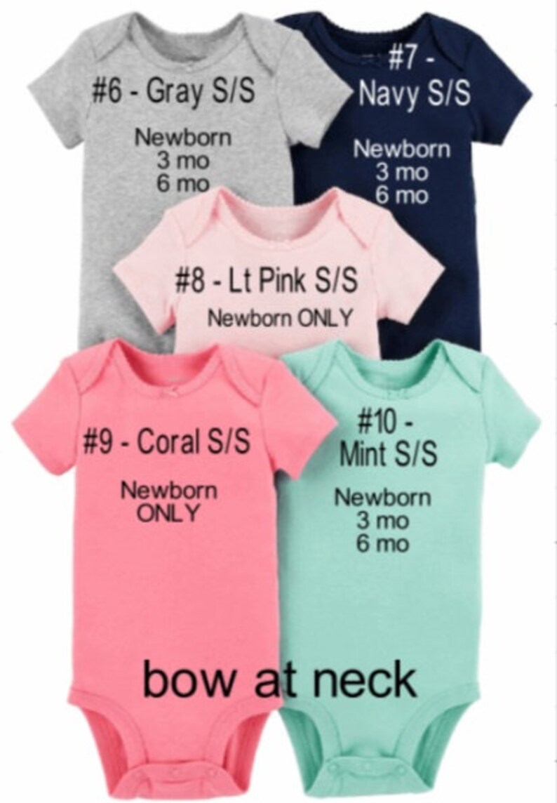May include: Five baby onesies in different colours and sizes. The onesies are labelled with numbers and colours, including grey, navy, light pink, coral, and mint. The onesies are all short-sleeved and have a bow at the neck. The sizes are newborn, 3 months, and 6 months.
