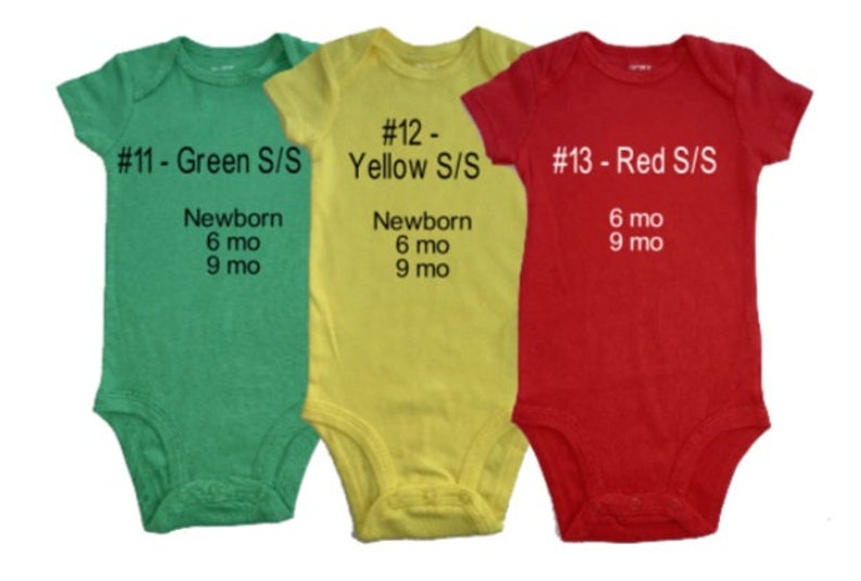 May include: Three baby onesies in green, yellow, and red. Each onesie has a number, colour, and size printed on the front. The onesies are available in newborn, 6 months, and 9 months sizes.