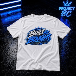 Könnte beinhalten: Ein weißes Kurzarm-T-Shirt mit einem blau-weißen Grafikdruck auf der Brust. Das Design zeigt ein Kronensymbol über dem Text BUILT NOT BOUGHT sowie kleineren Schriftzügen mit dem Inhalt NO EXCUSES, NO LIMITS, ALL IN, PROJECT BC.