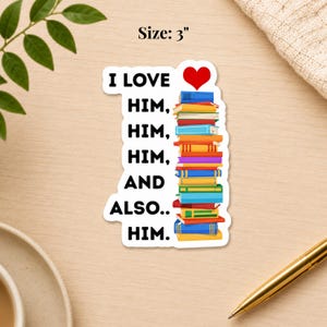 May include: A 3-inch sticker with the text "I LOVE HIM, HIM, HIM, AND ALSO.. HIM." A red heart is above a stack of colorful books. The sticker is on a wooden surface.