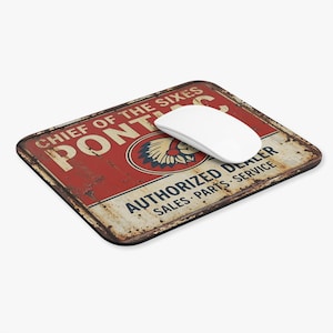 May include: Rectangular mousepad with a distressed red and white Pontiac sign design. The sign reads "CHIEF OF THE SIXES PONTIAC AUTHORIZED DEALER SALES PARTS SERVICE". A white wireless mouse rests on the pad.
