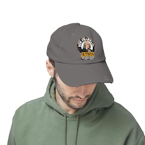 May include: A grey baseball cap with a distressed brim. The cap displays a circular graphic with the text "BEN FRANKLIN" and "ETHYL ANTI-KNOCK COMPOUND". The graphic includes a portrait of Benjamin Franklin.