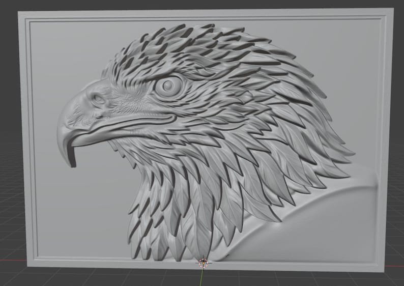 May include: A detailed, gray relief sculpture of an eagle's head in profile. The artwork features intricate feather detailing and a strong, hooked beak. The eagle is framed within a rectangular border, showcasing a classic, artistic style.