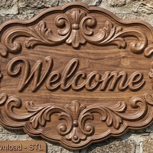May include: A dark brown wooden sign with a carved, ornate border featuring scrolling leaf patterns and the word Welcome embossed in the center. The sign has a smooth, polished finish and a rectangular shape with rounded, decorative edges.