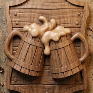 May include: A wooden wall plaque featuring a relief carving of two beer mugs clinking together with overflowing foam. The design is mounted on a shield-shaped backboard with horizontal plank detailing. The text digital download STL is visible.