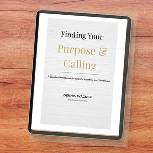 May include: A digital tablet displaying a book cover titled Finding Your Purpose & Calling, A Guided Workbook for Clarity, Identity, and Direction by Dennis Wagner, Storyboard Coaching, featuring black and gold text on a white textured background.