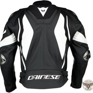May include: Black and white motorcycle jacket with the brand name "DAINESE" printed across the lower back. The jacket features white accents on the shoulders and sides, with protective padding on the elbows. The back of the jacket is visible.