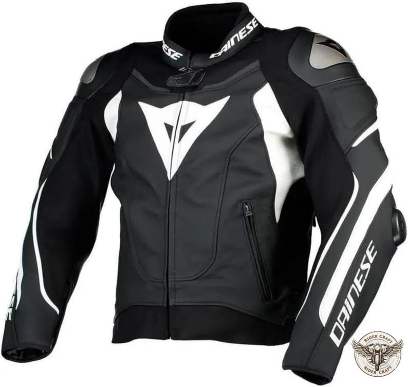 May include: Black and white motorcycle jacket with the brand name "DAINESE" on the collar and sleeve. The jacket features white accents on the shoulders, sleeves, and chest, with a large white logo on the chest. The jacket has a zipper closure and protective padding.