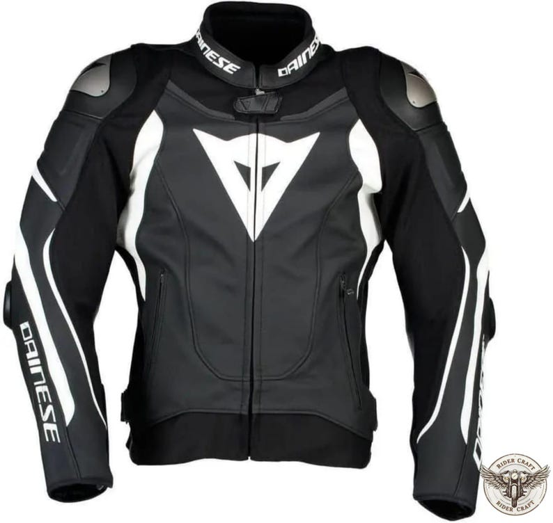 May include: Black and white motorcycle jacket with the brand name "Dainese" on the collar and sleeves. The jacket features white accents and a large white logo on the chest. Includes shoulder and elbow protection.