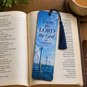 May include: A blue bookmark with the text "I am the LORD thy God" and a scenic image of wind turbines in the ocean. The bookmark is placed in an open book with the text of Isaiah 43:3.