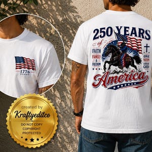 May include: A white t-shirt featuring a graphic on the back of a rider on a black horse with an American flag, the text 250 YEARS OF FAITH FAMILY & FREEDOM ONE NATION UNDER GOD AMERICA, and a small American flag with 1776 on the front chest area.