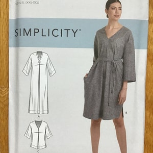 May include: A sewing pattern for a dress with a V-neck, long sleeves, and a tie belt. The pattern is from Simplicity and is for sizes XXS-XXL. The pattern is called K9139.