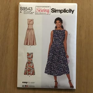 May include: Simplicity sewing pattern number S9543 for a sleeveless dress with a boat neck. The pattern includes two different dress styles, one with a floral print and one with a polka dot print. The pattern is labelled "easy-to-sew".