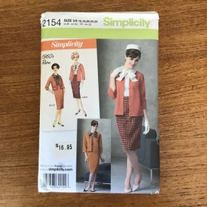 May include: A Simplicity sewing pattern envelope 2154 for a 1960s style suit featuring a jacket, skirt, and blouse. The cover displays illustrations and a photograph of the finished garments in coral and plaid, with text including size U5 16-24.