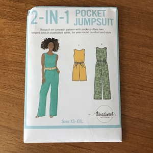 May include: A sewing pattern for a 2-in-1 pocket jumpsuit. The cover features a teal jumpsuit with a belt, and illustrations of yellow and green jumpsuits. Text includes "2-IN-1 POCKET JUMPSUIT" and "Sizes XS-XXL". The brand name "threadcount patterns" is also visible.