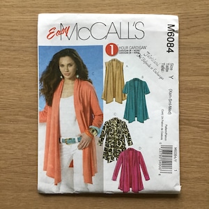 May include: A handmade wooden sign with the text "Welcome to our home" in a handwritten style. The sign is painted white with black lettering and features a small, decorative heart. It is designed for indoor or outdoor use.