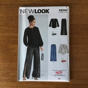 May include: A New Look sewing pattern, K6582, featuring a woman in a black blouse and wide-leg pants with a side slit. The pattern includes illustrations of different blouse and pants styles. The size is U.S. 10-18.