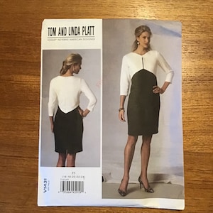 May include: A sewing pattern by Tom and Linda Platt for a dress. The pattern features a two-tone dress design with a white top and a black skirt. The pattern includes sizes 16-18-20-22-24. The Vogue Patterns American Designer logo is visible.