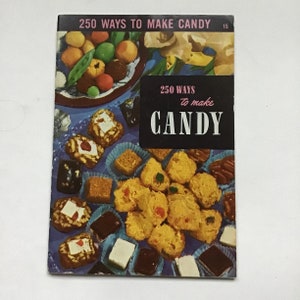 May include: A vintage cookbook titled "250 Ways to Make Candy" with a black and white cover. The cover features a variety of colorful candies and sweets, including chocolates, coconut clusters, and fruit-filled treats. The book is open to a page with a display of candies.
