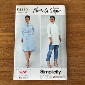 May include: A Simplicity sewing pattern, K8830 Mimi G Style, featuring two shirt dress designs. The pattern includes sizes U.S. 16-24. The cover shows a woman wearing a blue striped dress and a white shirt with jeans.