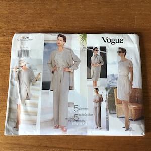 May include: Vogue pattern 1576, a sewing pattern for a five-garment wardrobe. The image shows a woman in a light-coloured suit, dress, and separates. The pattern includes the text "vestiare, 5 garment wardrobe, vetements reversible."