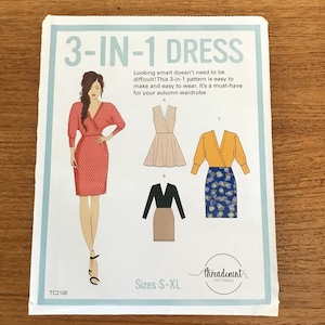 May include: A sewing pattern for a "3-IN-1 DRESS" with dress style illustrations. The pattern includes sizes S-XL and features a red polka dot dress, a beige dress, and a yellow top with a blue skirt. The text says "threadcount PATTERNS".