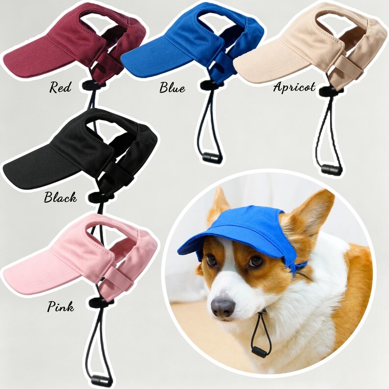 May include: A collection of pet visors in red, blue, apricot, black, and pink, each featuring an adjustable chin strap with a black toggle. A dog is shown wearing the blue visor, which has ear holes and a brim to shade the eyes from the sun.